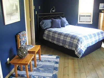 a bedroom with a bed and a table and a chair at Mountain Springs Nature Retreat in Kaleden