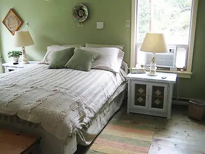 a bedroom with a bed with two tables and two lamps at Mountain Springs Nature Retreat in Kaleden