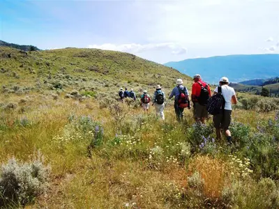 a group of people walking on a hill at Mountain Springs Nature Retreat in Kaleden