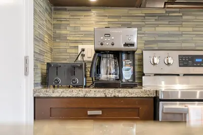 a kitchen with a coffeemaker and a coffee maker at Chic Haven Stylish 3Bedroom in Harrison Hot Springs
