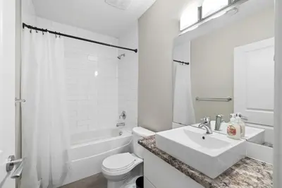 a white bathroom with a sink and a toilet at 1 bedroom in Edmonton