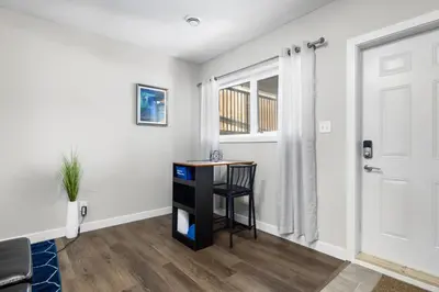 a living room with a desk and a window at 1 bedroom in Edmonton