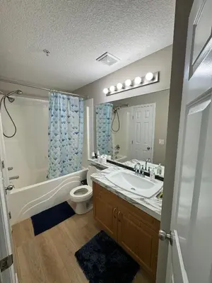 a bathroom with a sink and a tub and a toilet at The Bloom Haven in Edmonton