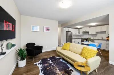 a living room with a couch and a kitchen at 2-bedroom in Edmonton