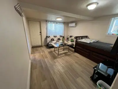 a living room with a bed and a couch at Nanaimo Nest in Nanaimo