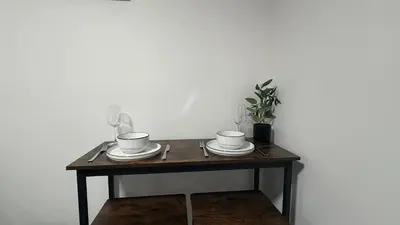 a wooden table with three cups and saucers on it at Cozy & Quiet Calgary 2BR Suite in Calgary