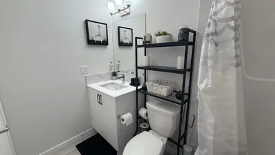 a bathroom with a white toilet and a sink at Cozy & Quiet Calgary 2BR Suite in Calgary