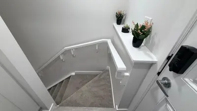 a white staircase with two potted plants on it at Cozy & Quiet Calgary 2BR Suite in Calgary