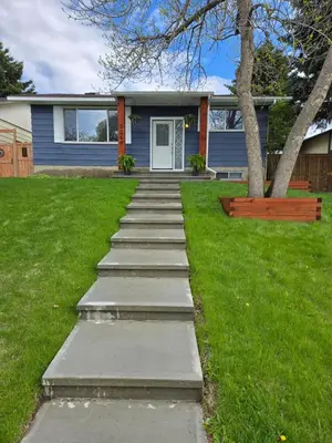 a pathway in front of a house with a tree at A Little R and R Private Sauna Cold and Hot Plunge in Calgary
