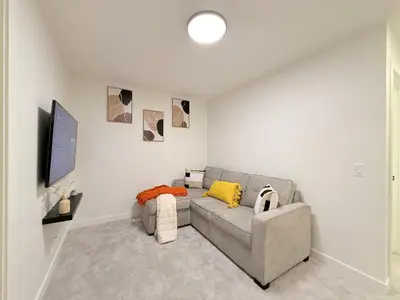 a living room with a couch and a tv at Casa Koko in Calgary