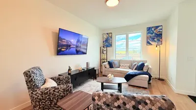 a living room with two chairs and a couch at La Maison de Koko in Calgary