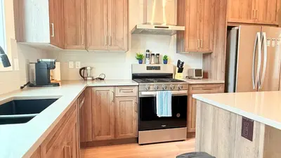 a kitchen with wooden cabinets and a stove top oven at La Maison de Koko in Calgary