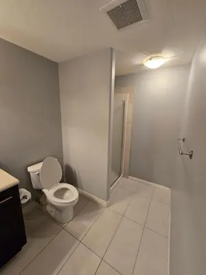 a bathroom with a toilet and a sink at Basement Suite Private Entry Fort McMurray in Fort McMurray