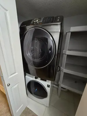 a washer and dryer sitting in a room at Basement Suite Private Entry Fort McMurray in Fort McMurray