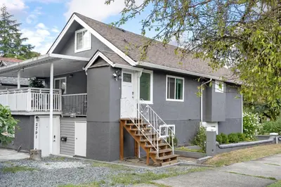 a gray house with a staircase in front of it at Callister BNB in Vancouver