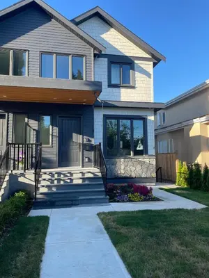 a house with a walkway in front of it at 3 bed duplex in Kitsilano 10 min to airport and 10 min to downtown in Vancouver