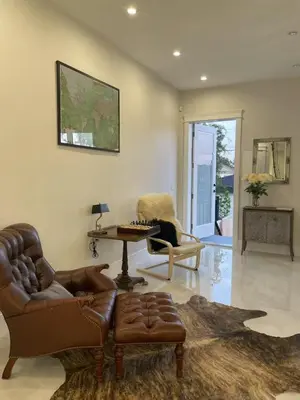 a living room with a couch and a table and chairs at 3 bed duplex in Kitsilano 10 min to airport and 10 min to downtown in Vancouver