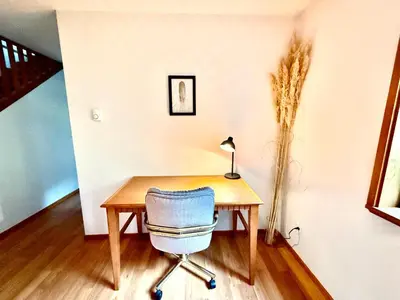 a desk with a chair and a lamp on it at Eagles Nest - epic blufftop cabin Squamish in Upper Squamish