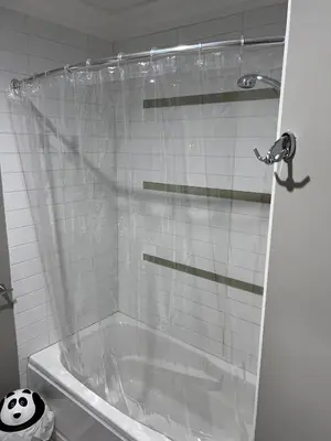 a shower with a plastic shower curtain in a bathroom at Vancouver Comfort Home 10 min to YVR airport, Close to Downtown in Vancouver