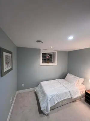 a bedroom with a bed and a window in it at Vancouver Comfort Home 10 min to YVR airport, Close to Downtown in Vancouver