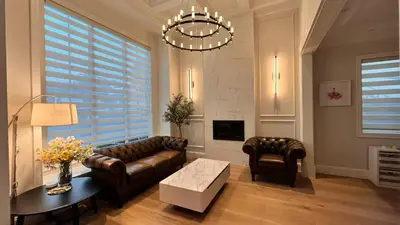 a living room with a leather couch and a table at Vancouver Richmond Villa 41 in Richmond