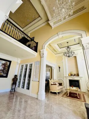 a large living room with a chandelier and a fireplace at Vancouver Richmond Villa 40 in Richmond