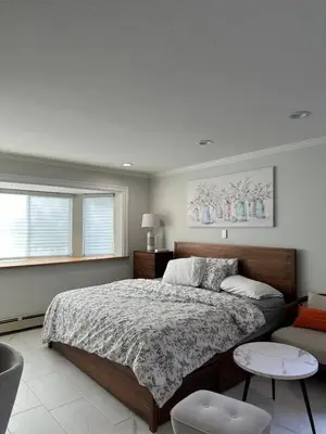 a bedroom with a large bed and a couch at Vancouver Richmond Villa 40 in Richmond