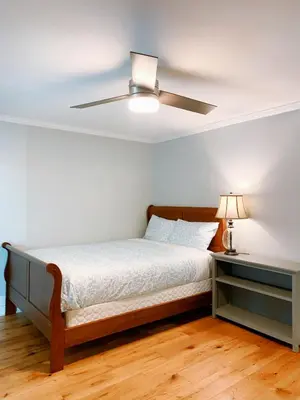a bedroom with a bed and a ceiling fan at Northern Stay in North Vancouver