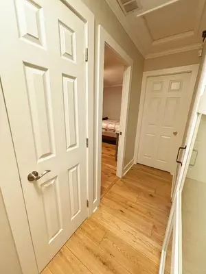 an empty hallway with a white door and stairs at Northern Stay in North Vancouver