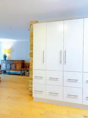 a large white cabinet in a room with wooden floors at Northern Stay in North Vancouver
