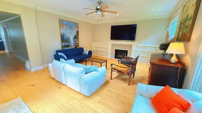 a living room with two blue couches and a fireplace at Northern Stay in North Vancouver