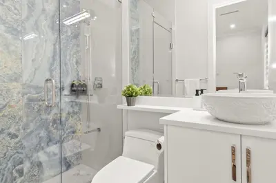 a bathroom with a shower and a toilet and a sink at Spacious 6BR Entire Home Sleeps 14 Private Parking Pet-Friendly Near Vancouver in Surrey