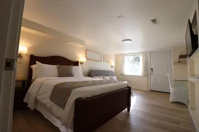 a bedroom with a large bed and a window at Victoria Gorge Waterway Vacation Home in Victoria