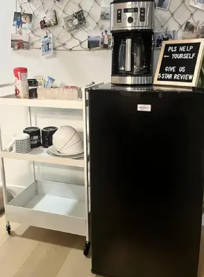 a coffee maker on top of a black refrigerator at Affordable Cozy Bedroom Close to YYC Airport in Calgary