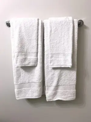 two towels hanging on a towel rack in a bathroom at Affordable Cozy Bedroom Close to YYC Airport in Calgary