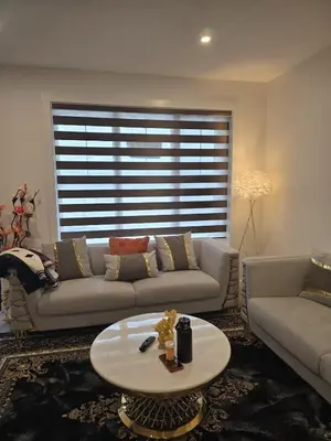 a living room with a couch and a coffee table at Modern Comfort - With AC in Calgary