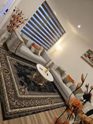 a living room with a couch and a rug at Modern Comfort - With AC in Calgary