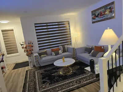 a living room with a couch and a table at Modern Comfort - With AC in Calgary