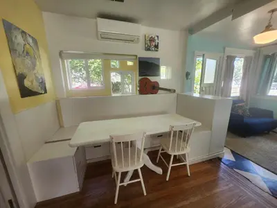 a small kitchen with a table and two chairs at Lakeview Suite by Trout Lake in Vancouver
