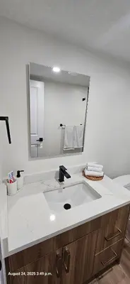 a bathroom with a sink and a large mirror at 1 BR suite near WEM, with fast WiFi and Equipped kitchen in Edmonton