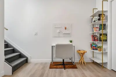 a white room with a desk and a chair at Two Bedroom Townhouse with AC Garage Parking and Wifi in Calgary