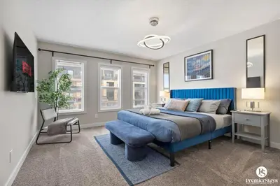 a bedroom with a blue bed and a blue chair at Large Luxury Home Featuring Entertain Room with Karaoke Air Hockey and Pool Table in Calgary