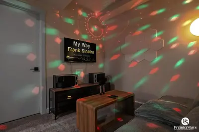 a living room with a tv and a couch at Large Luxury Home Featuring Entertain Room with Karaoke Air Hockey and Pool Table in Calgary