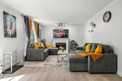 a living room with two couches and a fireplace at Bright 3-Bed Retreat Near the Zoo and Downtown in Calgary