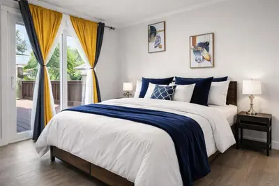 a bedroom with a large bed with blue and white sheets at Bright 3-Bed Retreat Near the Zoo and Downtown in Calgary