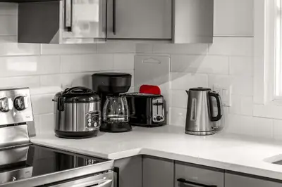 a kitchen counter with pots and pans on it at Bright 3-Bed Retreat Near the Zoo and Downtown in Calgary