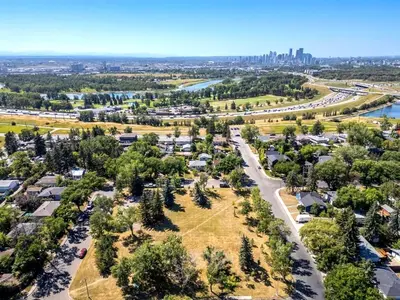 an aerial view of a park with a river and a city at Bright 3-Bed Retreat Near the Zoo and Downtown in Calgary