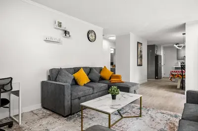 a living room with a couch and a table at Bright 3-Bed Retreat Near the Zoo and Downtown in Calgary