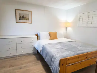 a white bedroom with a bed and a dresser at Private Cozy 2bdrm Sleep5pp Metrotown! Free Parking! Self Check-in! in Burnaby