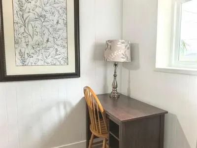 a desk with a lamp and a chair in a room at Private Cozy 2bdrm Sleep5pp Metrotown! Free Parking! Self Check-in! in Burnaby